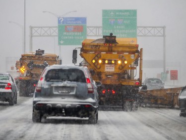 Snow plows join traffic on eastbound Highway 20 during Friday's storm. More snow is expected throughout the day.