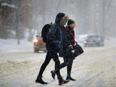 People cross Sherbrooke St. W. during snow storm Friday were braving wind and blowing snow. Montreal motorists were urged to stay off the roads.
