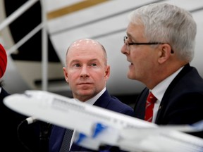 Bombardier CEO Alain Bellemare listens as federal transport Minister Marc Garneau speaks during a press conference at Bombardier in Montreal on Tuesday February 7, 2017.