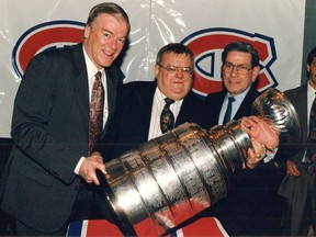 Canadiens team physicians Dr. David Mulder (left) and Dr. Douglas Kinnear pose with Stanley Cup along with team trainer Eddie Palchak.