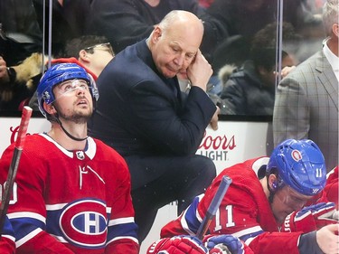Montreal Canadiens head coach Claude Julien stares at the floor after the Arizona Coyotes scored the winning goal with one minute to play in the game during third period of National Hockey League game in Montreal Monday February 10, 2020. Tomas Tatar, left, and Brendan Gallagher sit in front of him.