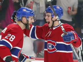 Montreal Canadiens Jake Evans celebrates the first goal of his NHL career with teammate Marco Scandella during first period of National Hockey League game against the Arizona Coyotes in Montreal Monday February 10, 2020.