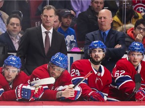 Canadiens associate coach Kirk Muller (left) and head coach Claude Julien watch action from behind bench.