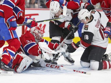 Montreal Canadiens Carey Price loses his goalie stick while holding off Arizona Coyotes Christian Dvorak and Conor Garlan during second period of National Hockey League game in Montreal Monday February 10, 2020.