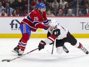 Montreal Canadiens' Jeff Petry pushes Arizona Coyotes Taylor Hall to the ice during second period in Montreal on Feb. 10, 2020.