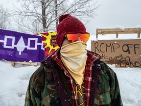 Kahnawake resident Wenhniseri:io is standing in solidarity with the Wet’suwet’en anti-pipeline blockade of the Candiac rail line in Kahnawake on Monday February 10, 2020. Dave Sidaway / Montreal Gazette ORG XMIT: 63937