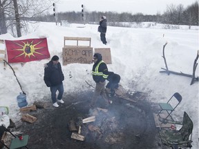 Protesters near the train track crossing the land of Kahnawake. They are blocking the CP train tracks in the town and stopping the Candiac commuter train from operating on Tuesday February 11, 2020.