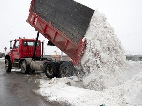 A contracted dump truck operator unloads into the sewer system at one of the approved sewer dumps in Montreal, on Thursday, February 13, 2020. The sewer dump is located under the Jacques Cartier Bridge and feeds in to one of the largest sewers in the city, which transports the melts snow to the water filtration plant in east end Montreal.