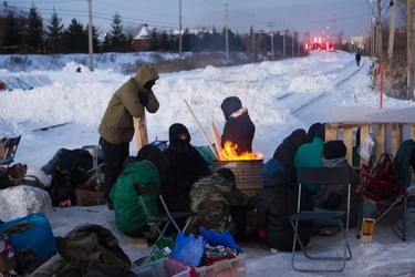 Protesters block the CN railway tracks near the St-Lambert train station south of Montreal early Friday, Feb. 21, 2020. They were there in solidarity with the Wet'suwet'en people who want the RCMP off their territory.