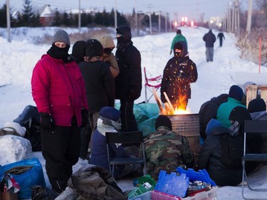 Protesters block the CN railway tracks near the St-Lambert train station south of Montreal early Friday, Feb. 21, 2020.