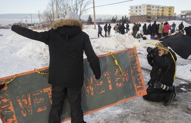 Eric St. Laurent yells at protesters blocking the CN railway tracks near the St-Lambert train station south of Montreal early Friday, February 21, 2020.
