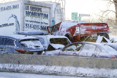 A pickup truck sits on top of a car at the scene of a multi-car accident on Highway 15 West in Laprairie on Wednesday, Feb. 19, 2020.