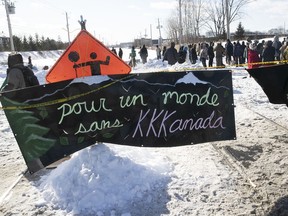 Protesters set up a blockade on the train tracks in Longueuil near Oak Ave. and St-Georges St. on Wednesday February 19, 2020, in support of the Wet'suwet'en.