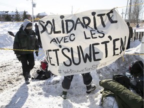 Protesters set up a blockade on the train tracks in Longueuil near Oak Ave. and St-Georges St. on Wednesday February 19, 2020, in support of the Wet'suwet'en.