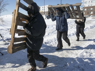 Protesters arrive with wooden pallets at blockade on the train tracks in Longueuil near Oak Ave. and St-Georges St. on Thursday February 20, 2020.