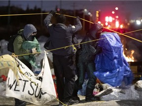 Longueuil police allow protestors to leave with their personal belongings Friday evening after having blocked the CN Rail lines in St-Lambert.