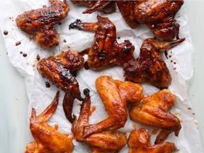 Julie Van Rosendaal coats half the wings in Buffalo sauce and half in hot garlic honey sauce.