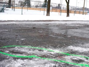 Green paint circles blood stains at the crime scene in Laval on Jan. 2.
