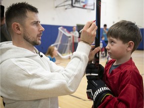 Canadiens' Tomas Tatar gives guidance to Jackson Seidman on how to choose the right length of stick.