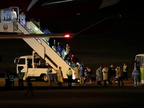 Australian passengers from the cruise ship Diamond Princess board a Qantas charter flight at Haneda airport in Tokyo, Japan February 19, 2020.