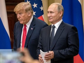 U.S. President Donald Trump, left,  and Russian President Vladimir Putin arrive to waiting media during a joint press conference after their summit on July 16, 2018 in Helsinki, Finland.