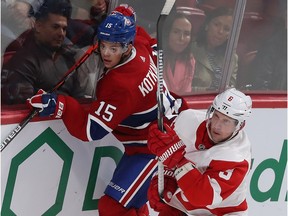 Montreal Canadiens' Jesperi Kotkaniemi goes into the boards with Detroit Red Wings' Justin Abdelkader (8) during third period in Montreal on Oct. 10, 2019.