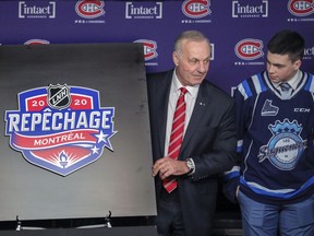 Hendrix Lapierre of the QMJHL’s Chicoutimi Saguenéens watches as Canadiens legend Guy Lafleur unveils the logo for the 2020 NHL Draft at the Bell Centre in Montreal on Feb. 10, 2020.