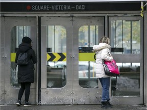 Commuters are seen entering Square-Victoria métro station in this file photo.