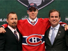 Montreal Canadiens' 17th overall pick Nathan Beaulieu poses with director of procurement and player development Trevor Timmins and team owner Geoff Molson at the 2011 NHL Entry Draft in St. Paul, Minn., on June 24, 2011.