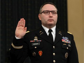 Key Impeachment witness Lt. Col. Alexander Vindman has been removed from his White House job on Friday, Feb. 7, 2020, but remains active duty in the military. He is shown here sworn in to testify before the House Intelligence Committee in the Longworth House Office Building on Capitol Hill on Nov. 19, 2019, in Washington, D.C. The committee heard testimony during the third day of open hearings in the impeachment inquiry against U.S. President Donald Trump, whom House Democrats say held back U.S. military aid for Ukraine while demanding it investigate his political rivals and the unfounded conspiracy theory that Ukrainians, not Russians, were behind the 2016 computer hacking of the Democratic National Committee.