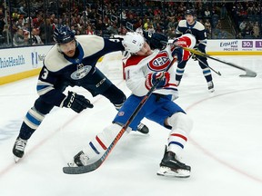 Blue Jackets' Seth Jones grabs Canadiens' Brendan Gallagher while chasing after the puck on Nov. 19, 2019, at Nationwide Arena in Columbus, Ohio.