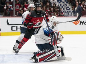 Canada's Marie-Philip Poulin looks on as a shot by teammate goes over the shoulder of U.S. goalie Aerin Frankel for a goal during Game 4 of the 2020 Rivalry Series at Rogers Arena on Feb. 5, 2020, in Vancouver.