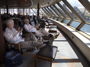 Passengers waiting to travel home are seen onboard the MS Westerdam cruise ship docked in Sihanoukville, Cambodia, on Saturday, Feb. 15, 2020. As the ship was declared free of the coronavirus (COVID-19 ) more than 1,000 passengers took charter flights to Phnom Penh. One elderly American woman was later found to be infected while transiting through Malaysia. The cruise ship departed Hong Kong on Feb. 1 with 1,455 passengers and 802 crew on board. There are currently 233 passengers and 747 crew members on board getting who were tested again.