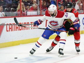 Senators' Colin White battles for puck control against Nate Thompson of the Montreal Canadiens in the first period at Canadian Tire Centre on Saturday, Feb. 22, 2020, in Ottawa.