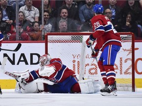 Goaltender Carey Price flails in a hopeless effort to stop the winning goal in overtime as defenceman Jeff Petry watches in dismay Tuesday night at the Bell Centre.