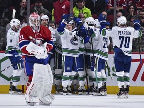 The Vancouver Canucks celebrate their victory against the Montreal Canadiens during overtime at the Bell Centre on February 25, 2020 in Montreal, Canada.