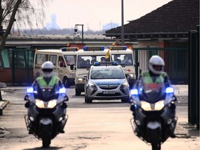 A convoy with German citizens from Wuhan drives toward the hospital DRK Clinics Berlin Koepenick after landing at Tegel Airport on Sunday, Feb. 9, 2020, in Berlin, Germany. Twenty German citizens are arriving from Wuhan will be quarantined at the clinic to undergo tests and observation for possible infection with coronavirus.