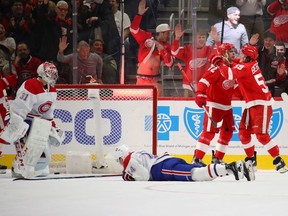 Wings' Andreas Athanasiou celebrates his winning goal with Tyler Bertuzzi, as Canadiens goalie Carey Price and rookie Nick Suzuki look on in disgust Tuesday night in Detroit.