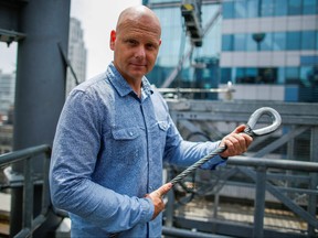 Aerialist Nik Wallenda holds a sample of a wire while he speaks with media as he prepares for a highwire walk over Times Square in New York, U.S., June 20, 2019. (REUTERS/Eduardo Munoz/File Photo)