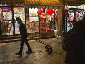 People walk on de la Gauchetière street in Montreal's Chinatown on Jan. 15, 2014.