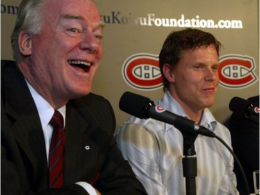 Canadiens captain Saku Koivu (centre), and one of his doctors, Dr. David Mulder from the Montreal General Hospital, and Montreal Candiens president Pierre Boivin have a laugh at a press conference to announce the creation of the Saku Koivu Foundation.