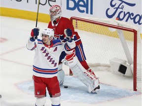 Canadiens goaltender Carey Price skates away from his goal while Rangers' Chris Kreider celebrates a goal by Ryan Strome (not shown) during third-period action Thursday night at the Bell Centre.