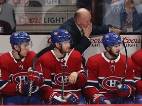 Montreal Canadiens head coach Claude Julien and players Nick Suzuki (14), Joel Armia (40) and Phillip Danault (24) during third period in Montreal on Feb. 27, 2020.