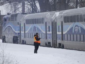 MONTREAL, QUE.: February 18, 2020 -- An EXO/AMT security guard watches as a commuter train returns to the downtown station after colliding with car at a level crossing on Gouin Boulevard in Montreal, on Tuesday, February 18, 2020. (Allen McInnis / MONTREAL GAZETTE) ORG XMIT: 63977