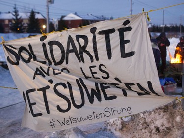 Protesters block the CN railway tracks near the St Lambert train station south of Montreal early Friday, February 21, 2020. They were there in solidarity with the Wet’suwet’en people who want the RCMP off their territory