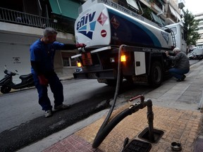 A worker delivers heating oil in Athens. The unusually warm January followed a warm December (the second warmest on record) and a mild November (the 11th warmest on record), effectively eliminating the first half of the winter heating season.