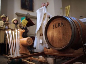 The bishop of the Jura blesses a barrel of Vin Jaune during the traditional event in Perrigny (eastern France) on Feb. 2, 2014. The festival is staged in the first week of February each year to celebrate release of the newly released vintage.