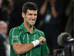 Serbia's Novak Djokovic celebrates after beating Austria's Dominic Thiem during their men's singles final match on day fourteen of the Australian Open tennis tournament in Melbourne on February 2, 2020.