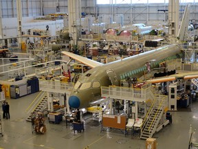 FILE PHOTO: An Airbus A220 passenger jet, formerly known as the Bombardier CSeries, stands in the final assembly line where the European company plans a $30 million investment to keep up with forecast demand, in Mirabel near Montreal, Quebec, Canada January 14, 2019. Airbus acquired the former Bombardier jet in 2018. REUTERS/Tim Hepher/File Photo