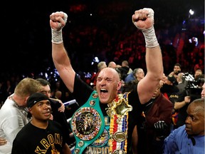 February 22, 2020 Tyson Fury celebrates with the belts after winning the fight against Deontay Wilder as referee Kenny Bayless looks on.